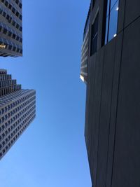 Low angle view of buildings against clear blue sky