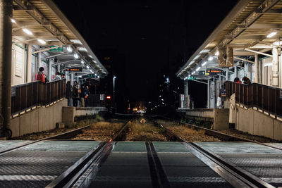 People at railroad station during night