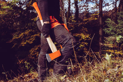 Woodcutter man with axe and chainsaw - the woodcutter serie