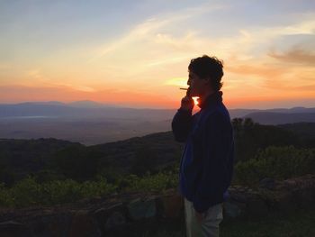 Silhouette of person standing on mountain