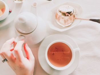 Cropped hand holding coffee cup