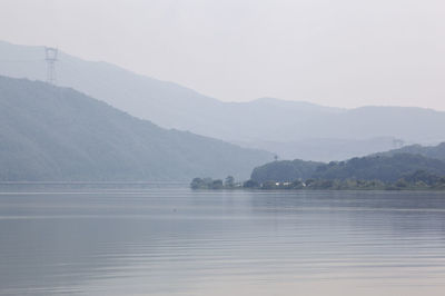 Idyllic shot of river and mountains against sky