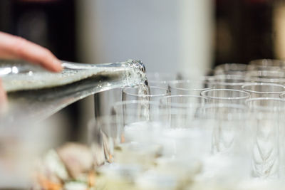 Close-up of hand pouring water in glass