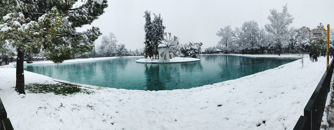 SCENIC VIEW OF FROZEN LAKE AGAINST TREES