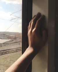 Close-up of man hand on glass window