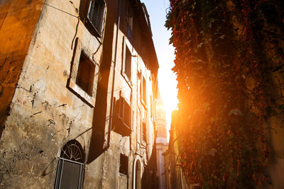 Residential buildings against sky during sunset