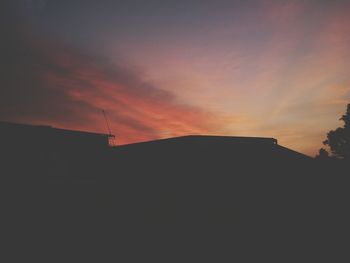 Silhouette of built structure at sunset