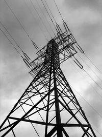 Low angle view of electricity pylon against sky