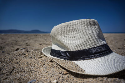 Close-up of hat on sand