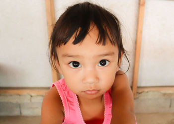 Close-up portrait of cute girl at home