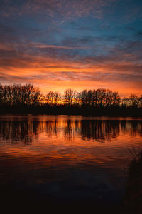 Scenic view of lake against romantic sky at sunset