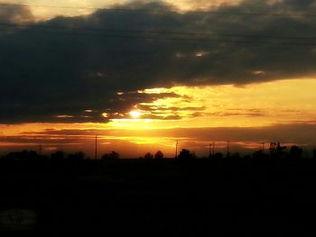 Silhouette of landscape against dramatic sky