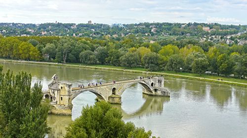 Arch bridge over river against sky