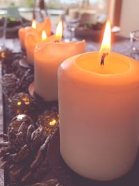 Close-up of lit candles on table