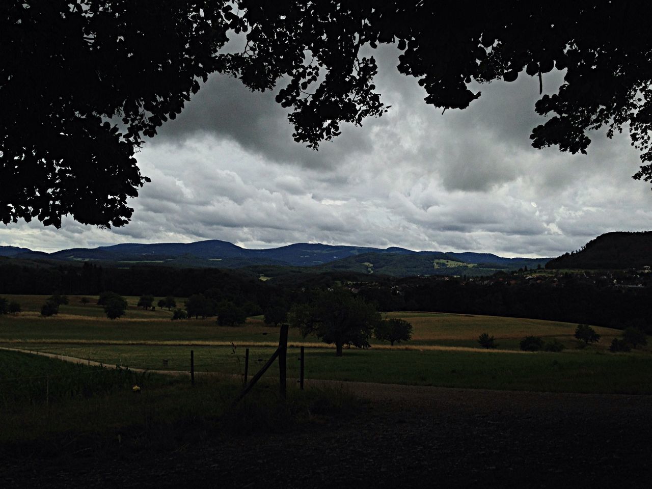 mountain, sky, landscape, tranquil scene, tranquility, tree, mountain range, scenics, cloud - sky, beauty in nature, nature, cloudy, field, cloud, non-urban scene, grass, countryside, idyllic, remote, outdoors