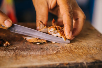 Close-up of man preparing food on cutting board