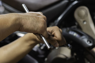 Close-up of man working on car