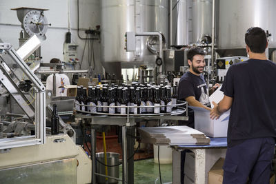 Men working in beer bottling plant