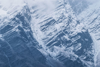 High angle view of snowcapped mountains and sea