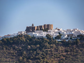 Buildings against clear blue sky