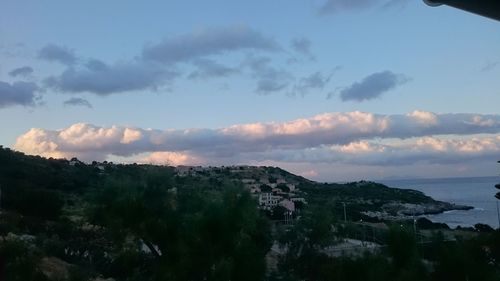 Scenic view of mountains against cloudy sky