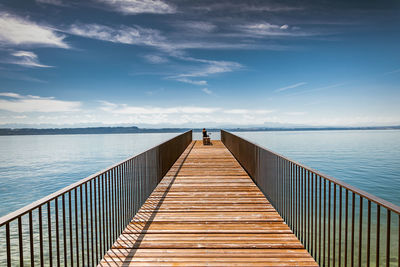 Pier over sea against sky