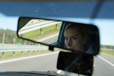 Portrait of young woman in car