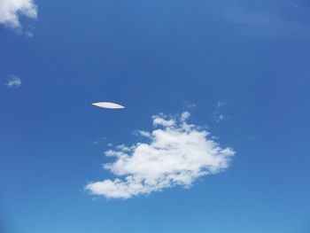 Low angle view of helicopter flying in sky