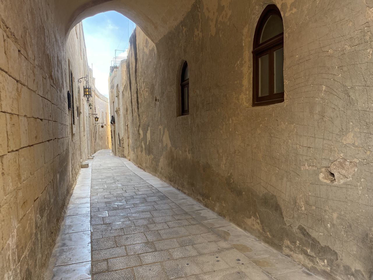 EMPTY FOOTPATH AMIDST OLD BUILDINGS