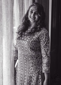 Young woman looking away while standing at home