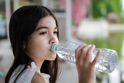 Close-up of girl drinking water