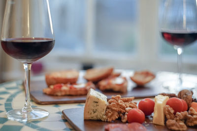 Close-up of wineglass with food on table