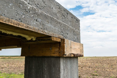 Low angle view of old building on field against sky