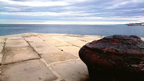 Scenic view of sea against cloudy sky