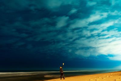 Man standing on beach against sky