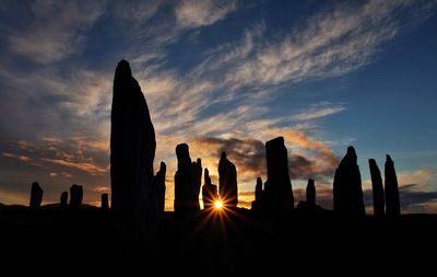 Silhouette of castle against sky during sunset