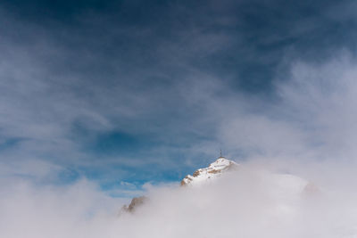 Low angle view of snowcapped mountain against sky