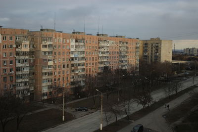 Buildings in city against sky during winter