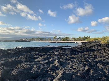 Scenic view of volcanic lava rocks by the sea against sky on isabela island galapagos 