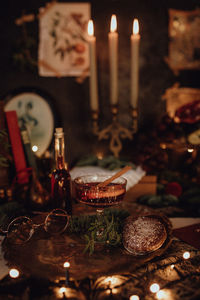 Christmas academia vintage harry potter table - fir, candles, wine, red decor, glasses, gingerbread