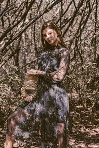 Portrait of young woman in forest