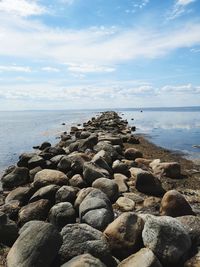 Rocks on beach against sky