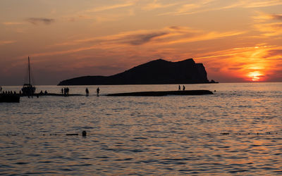 Scenic view of sea against orange sky