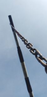 Low angle view of chain against sky