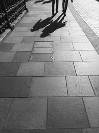 Low section of woman standing on tiled floor