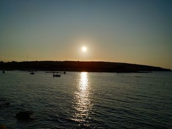 Scenic view of sea against clear sky during sunset