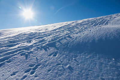 Snow covered mountains, with footprints in snow