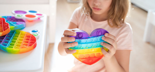 Midsection of woman holding multi colored candies