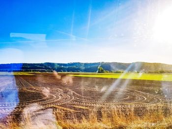 Scenic view of land against sky on sunny day