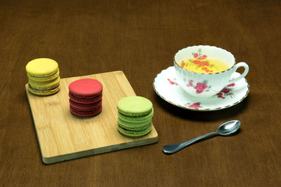 Close-up of macaroons and tea on table
